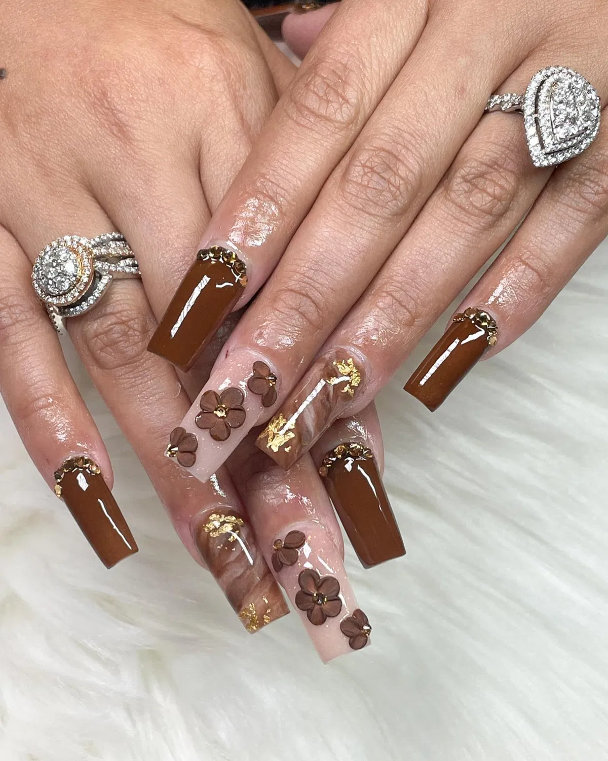 Glossy brown coffin nails with gold foil accents and brown florals