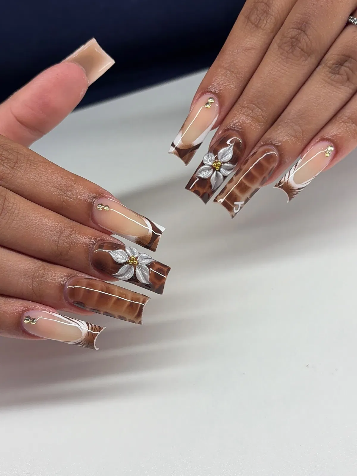 Coffin tortoiseshell nails with white linework and 3D flowers