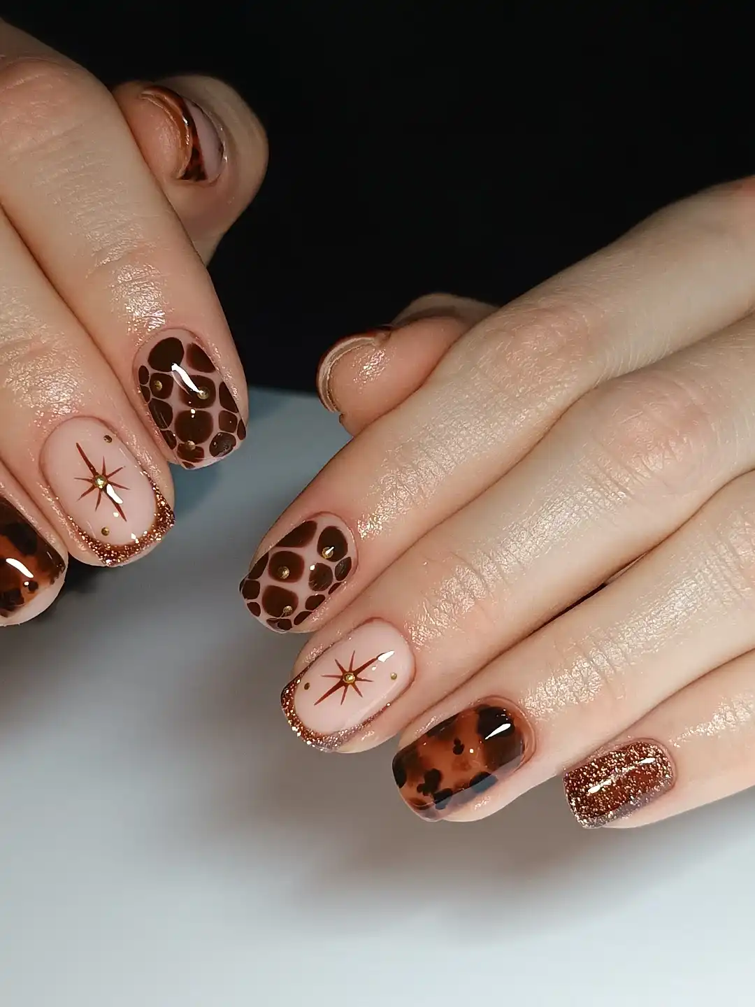 Brown spots, tortoiseshell-style accents, and glitter