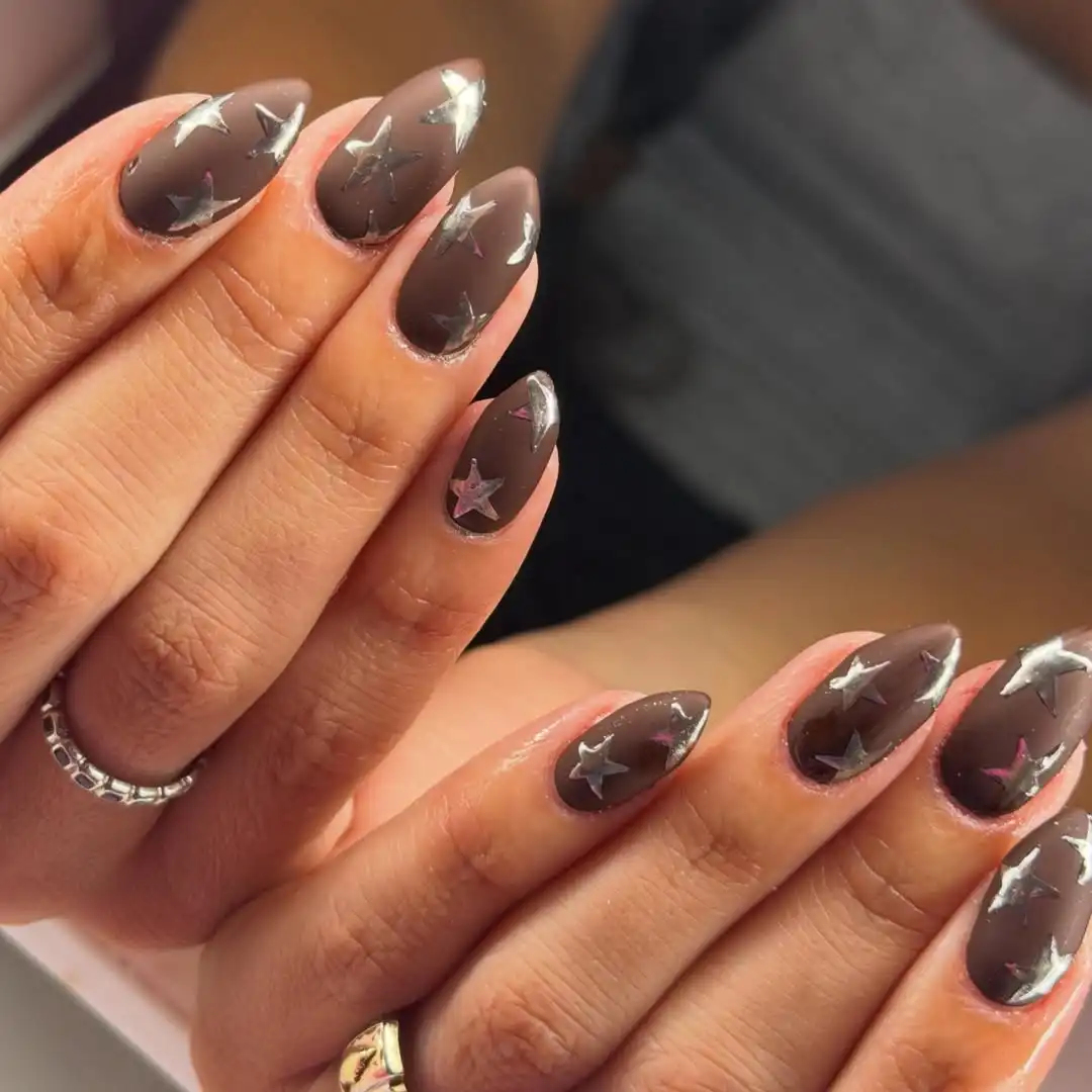 Taupe-brown nails with silver star overlays