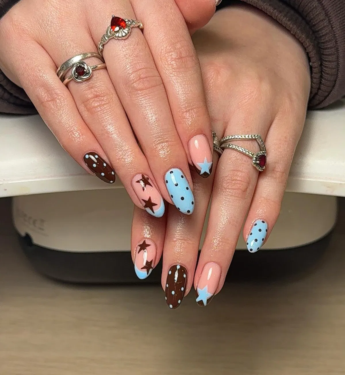 Nude, brown, and light blue with stars and dots