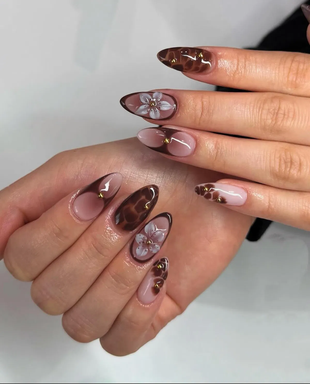 Nude pink with dark brown tips and floral accents