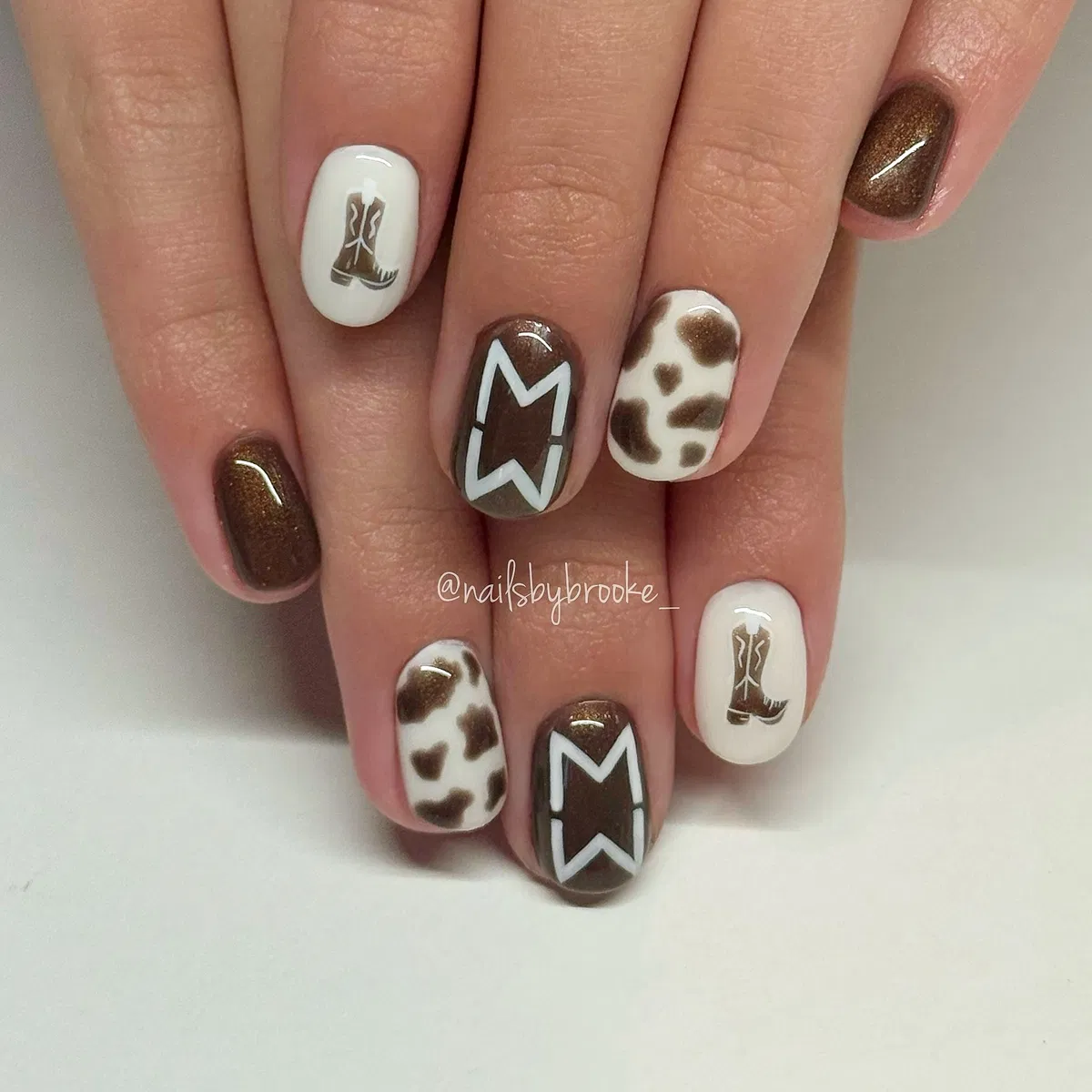 Brown and white mix with boot illustration and spots