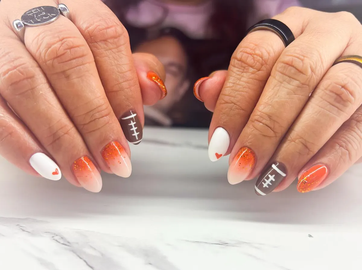 Orange ombré with white hearts and football accents