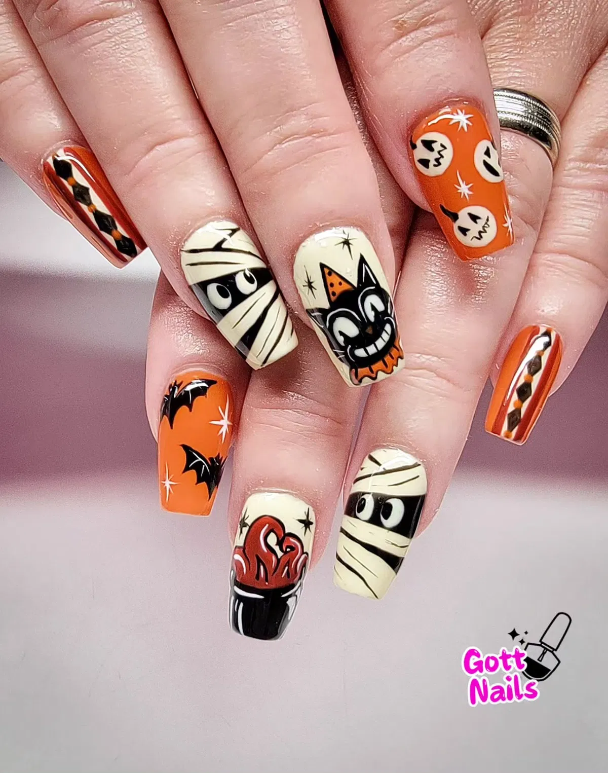 Bold orange-and-cream Halloween set with mummies, bats, and a grinning cat