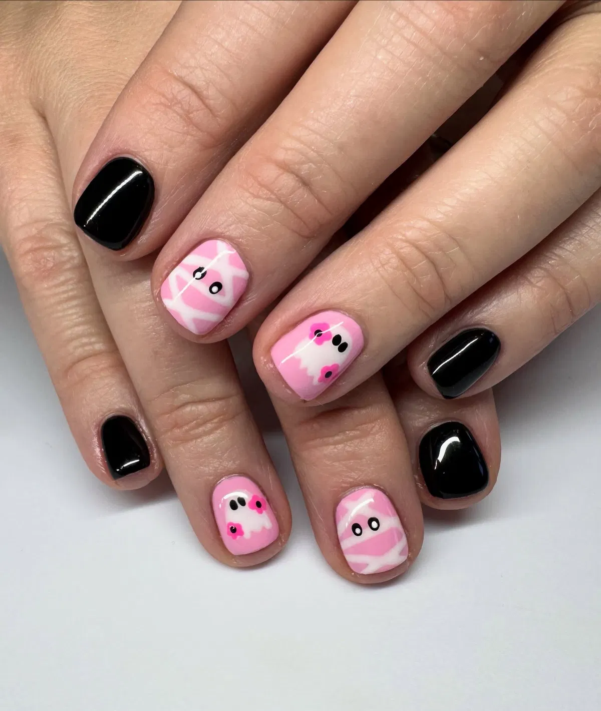 Short black nails with pink mummy and ghost accents