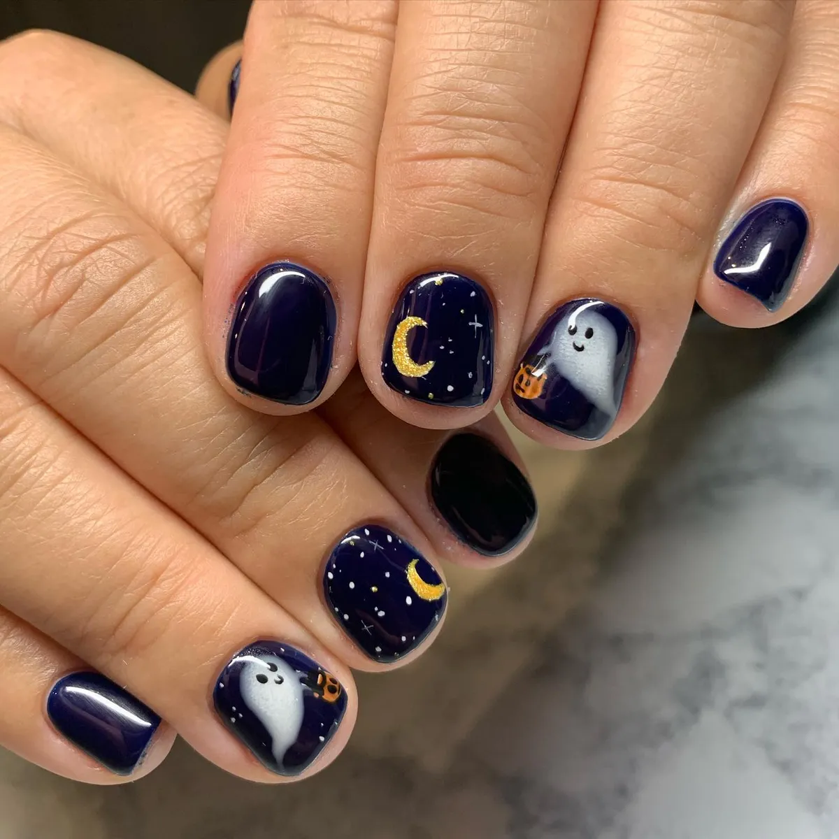 Navy night-sky nails with crescent moons and friendly ghosts