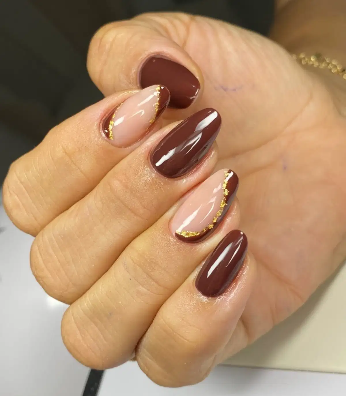 Nude-pink and dark brown French tips with gold edging