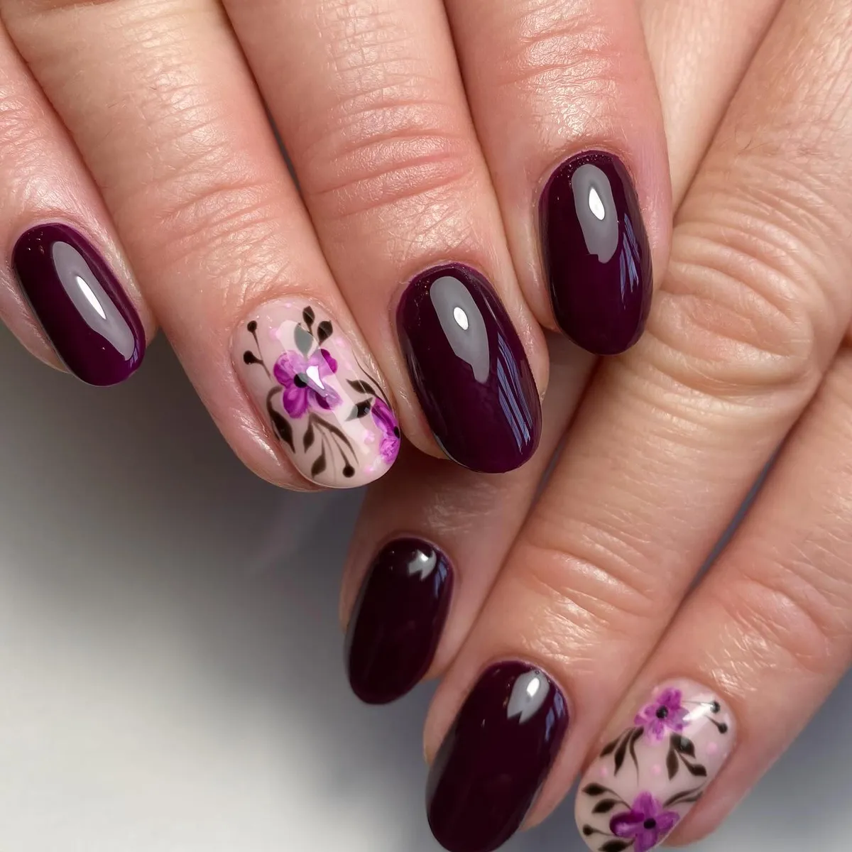 Dark plum with nude floral accent nails