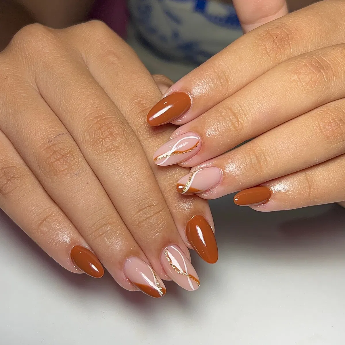 Diagonal brown accents with thin gold glitter lines