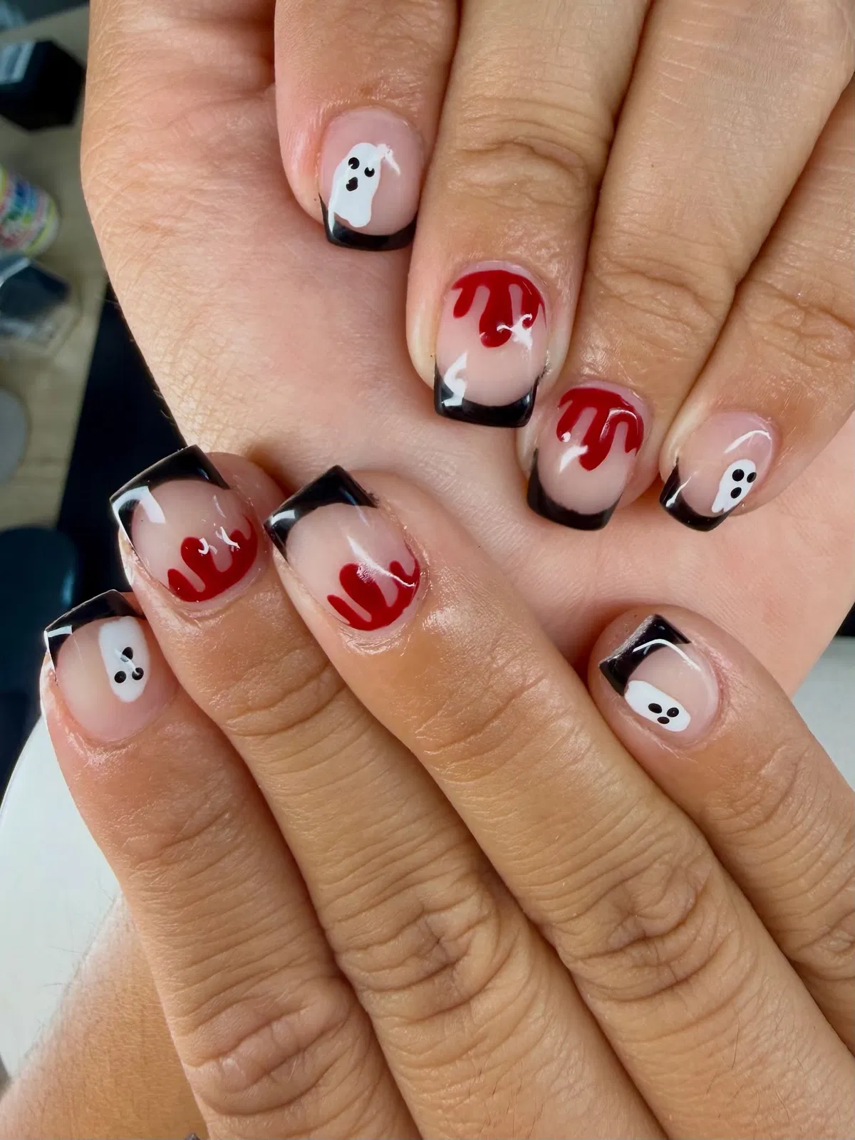 Black French tips with red drips and tiny ghosts