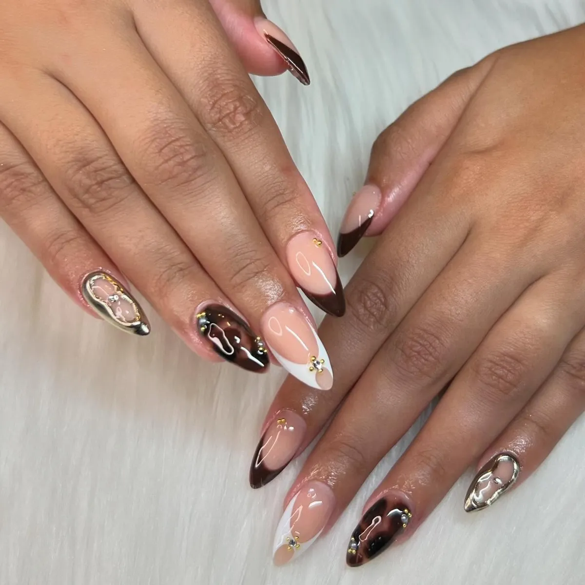 Mixed French tips with silver metallic accents and small gold embellishments