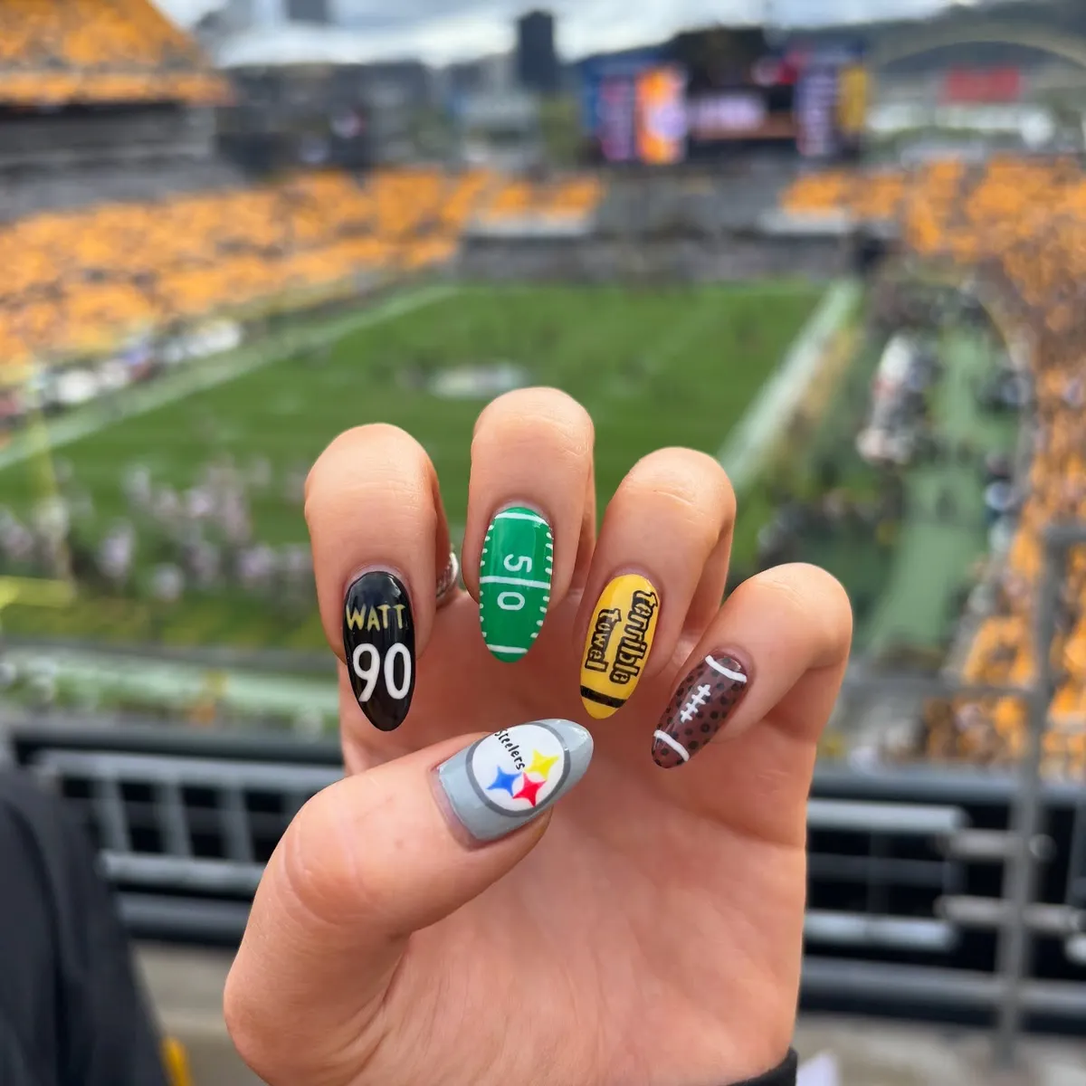 Mixed statement nails with visible text and field/football motifs