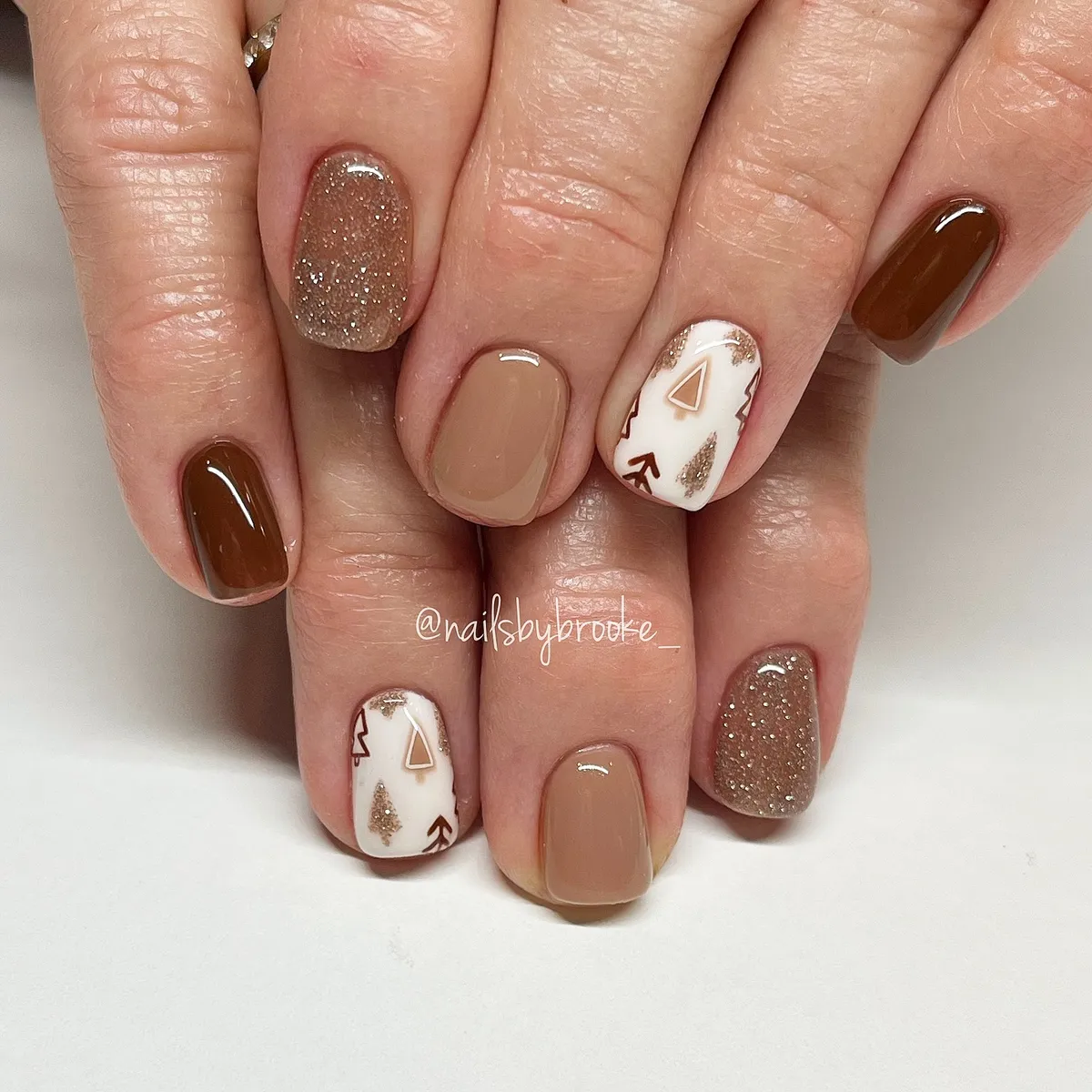 Taupe and brown with glitter accents and geometric white nails