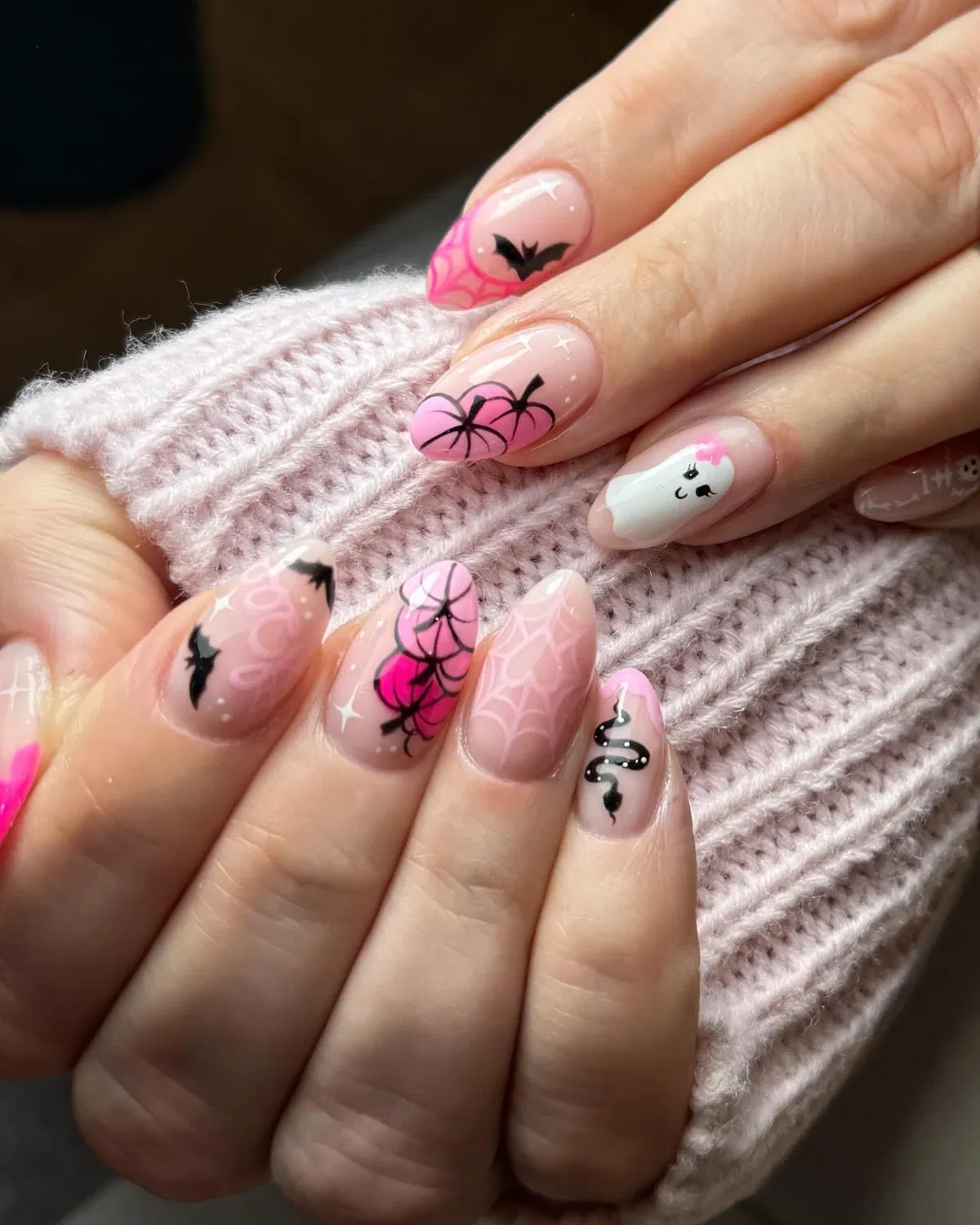 Pink Halloween-style mix: webs, pumpkins, ghost, and black line art