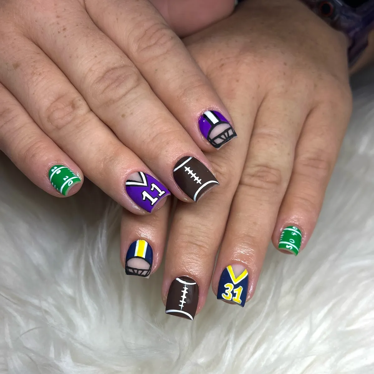 Helmet motifs with field lines, numbers, and football-lace nail