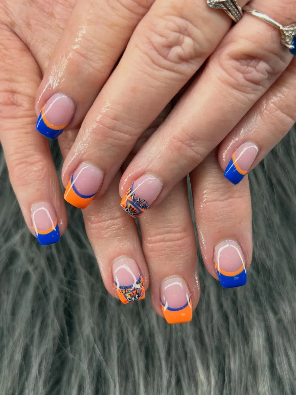 Orange-and-blue French tips with graphic decals