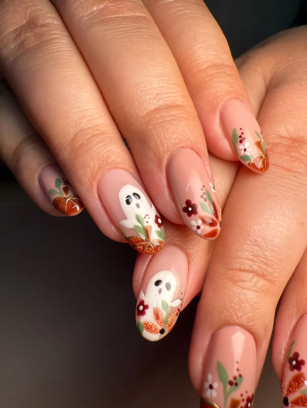 Nude-pink nails with ghost art and glitter tips