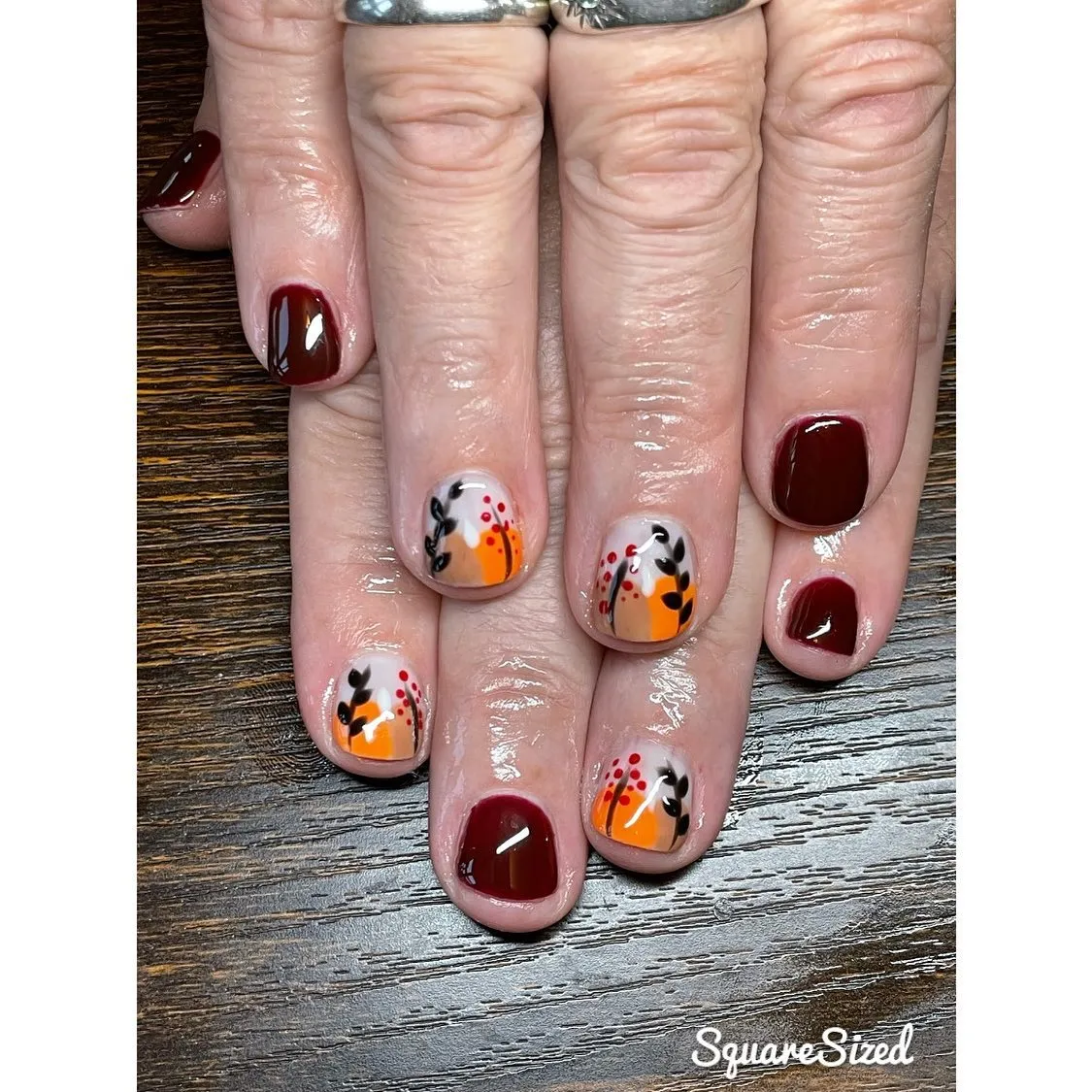 Burgundy solids with orange-and-leaf accents