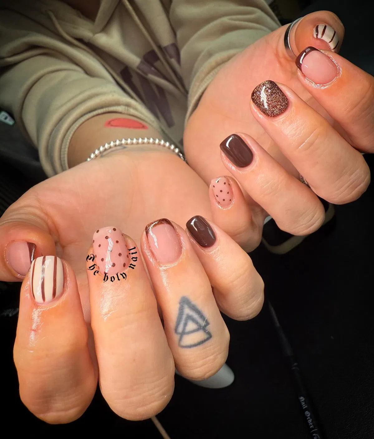 Nude-and-brown mix with French tips, dots, stripes, and glitter accent