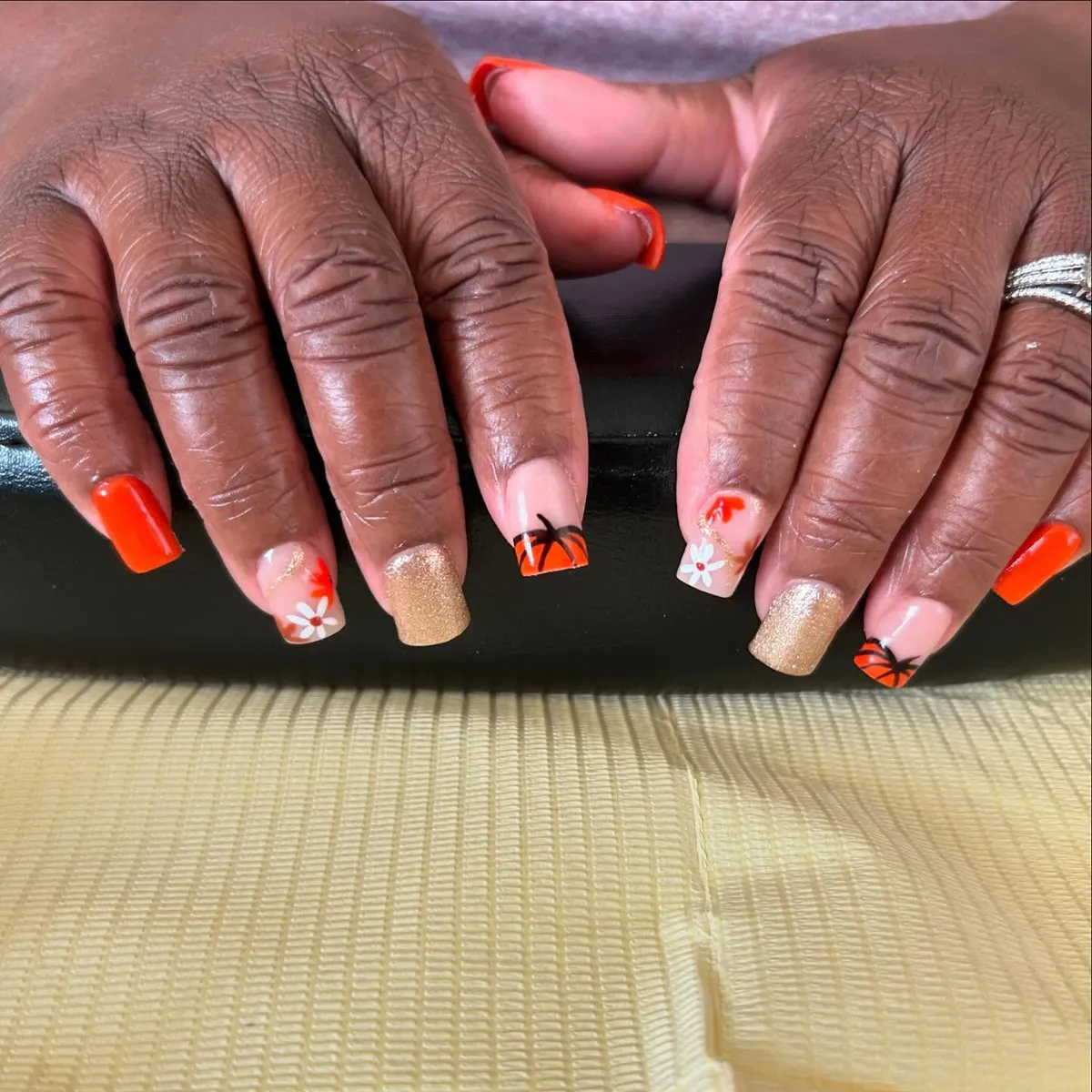 Bright orange and gold glitter with floral and line-art accents