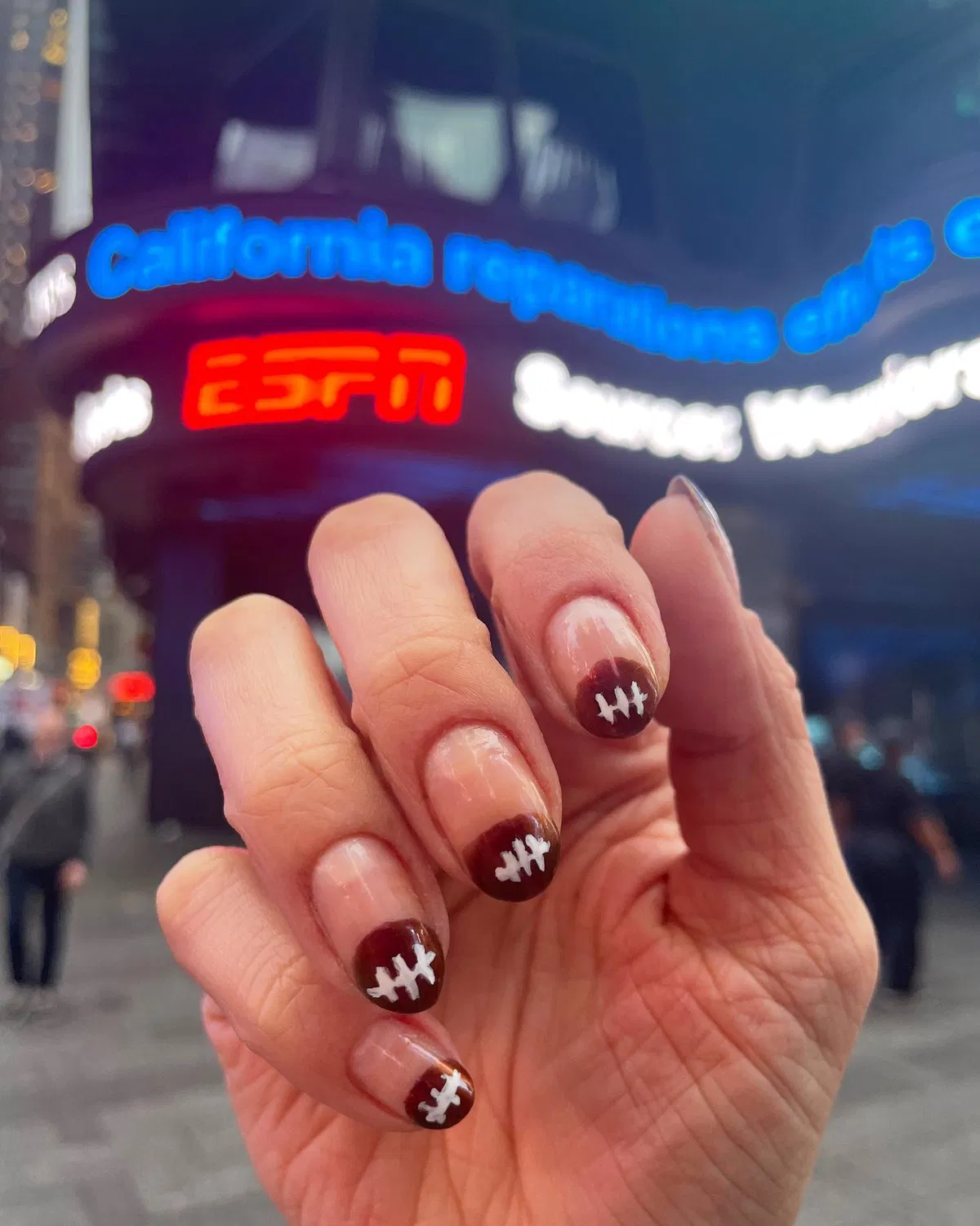Brown French tips with white lace motifs
