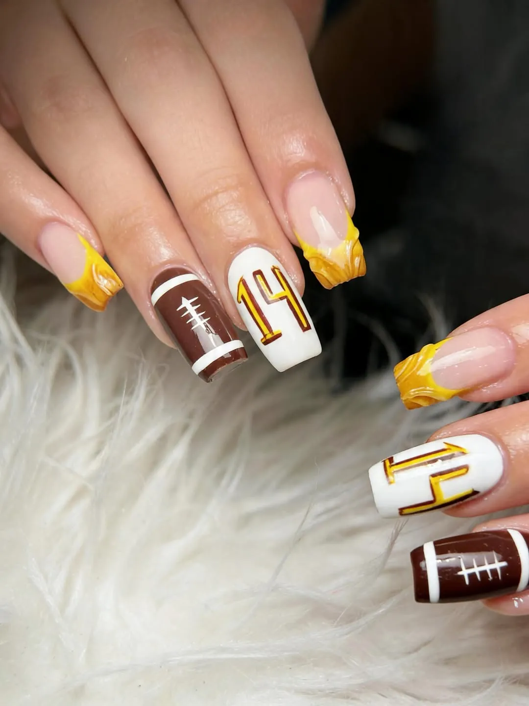 Yellow sculpted tips with numbered and football-lace accents