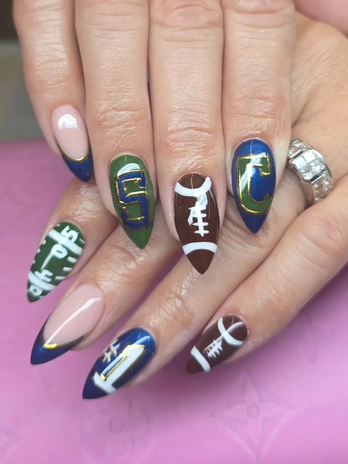 Lettered nails with football icons and gold outlines