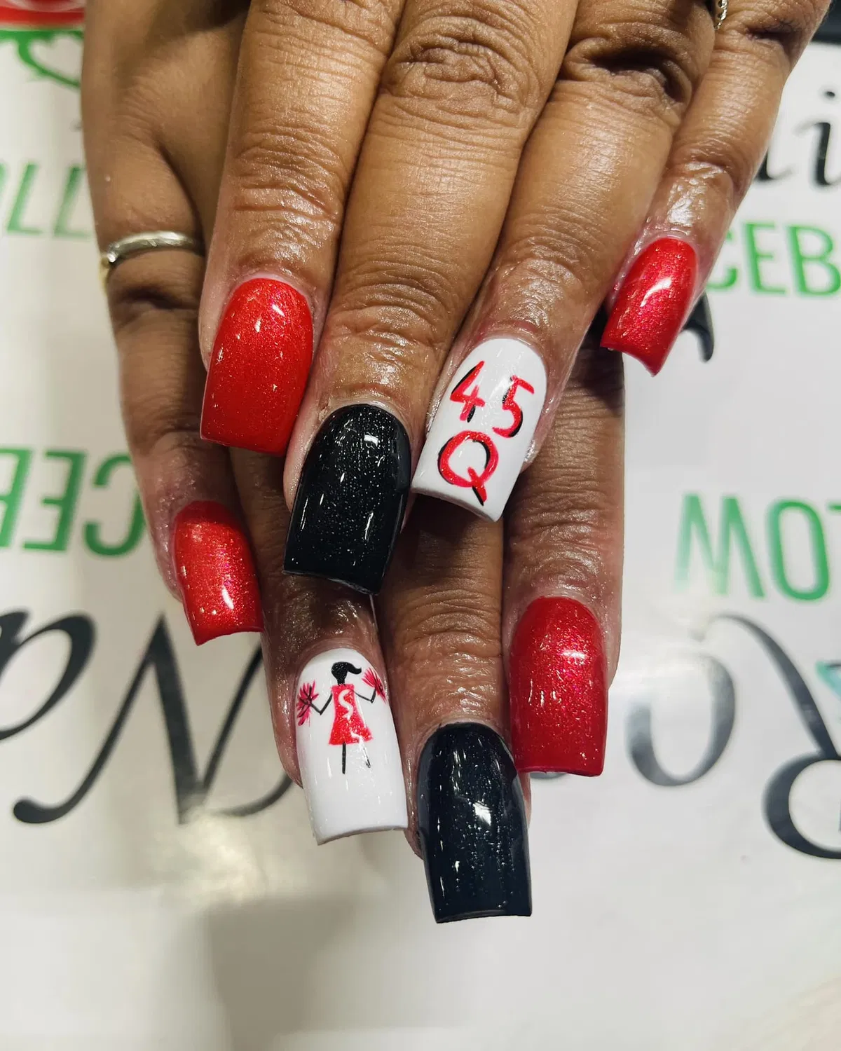 Red, black, and white set with “45 Q” text and a pom-pom graphic