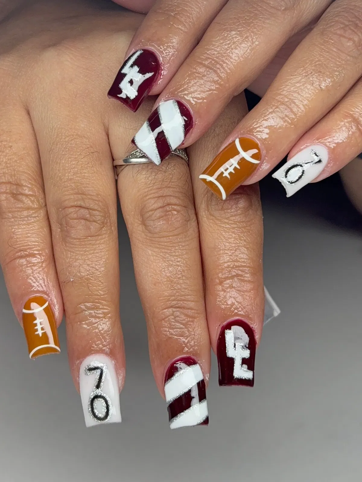 Maroon lettering with striped accents and glitter-outlined numbers