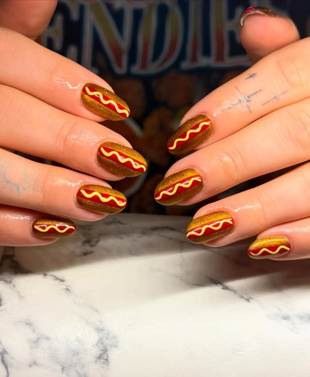 Gold Glitter Nails with Red Stripe and Yellow Wavy Line