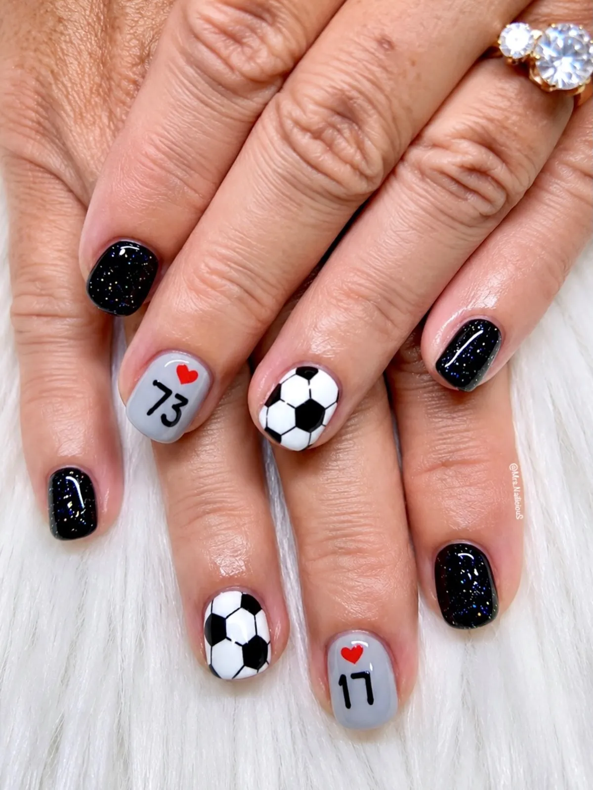 Black glitter and soccer ball nails with numbered hearts