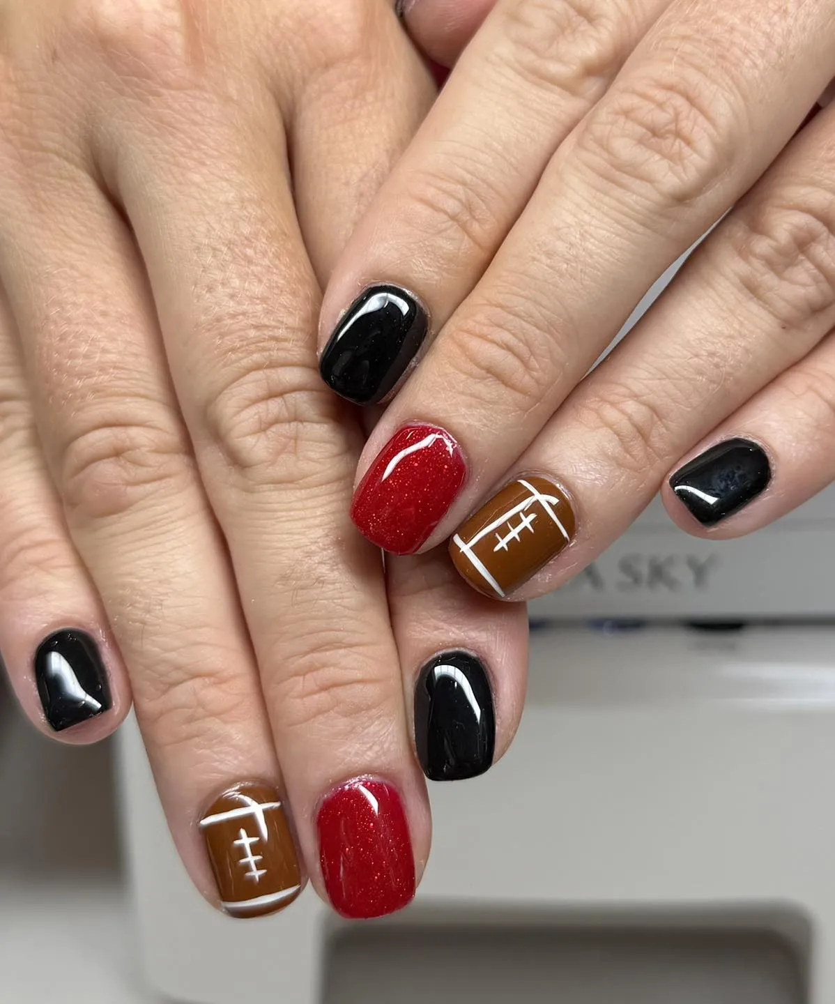 Black and red shimmer with classic football-lace accents