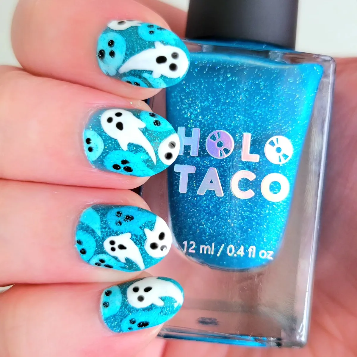 Blue glitter ghosts with visible bottle text