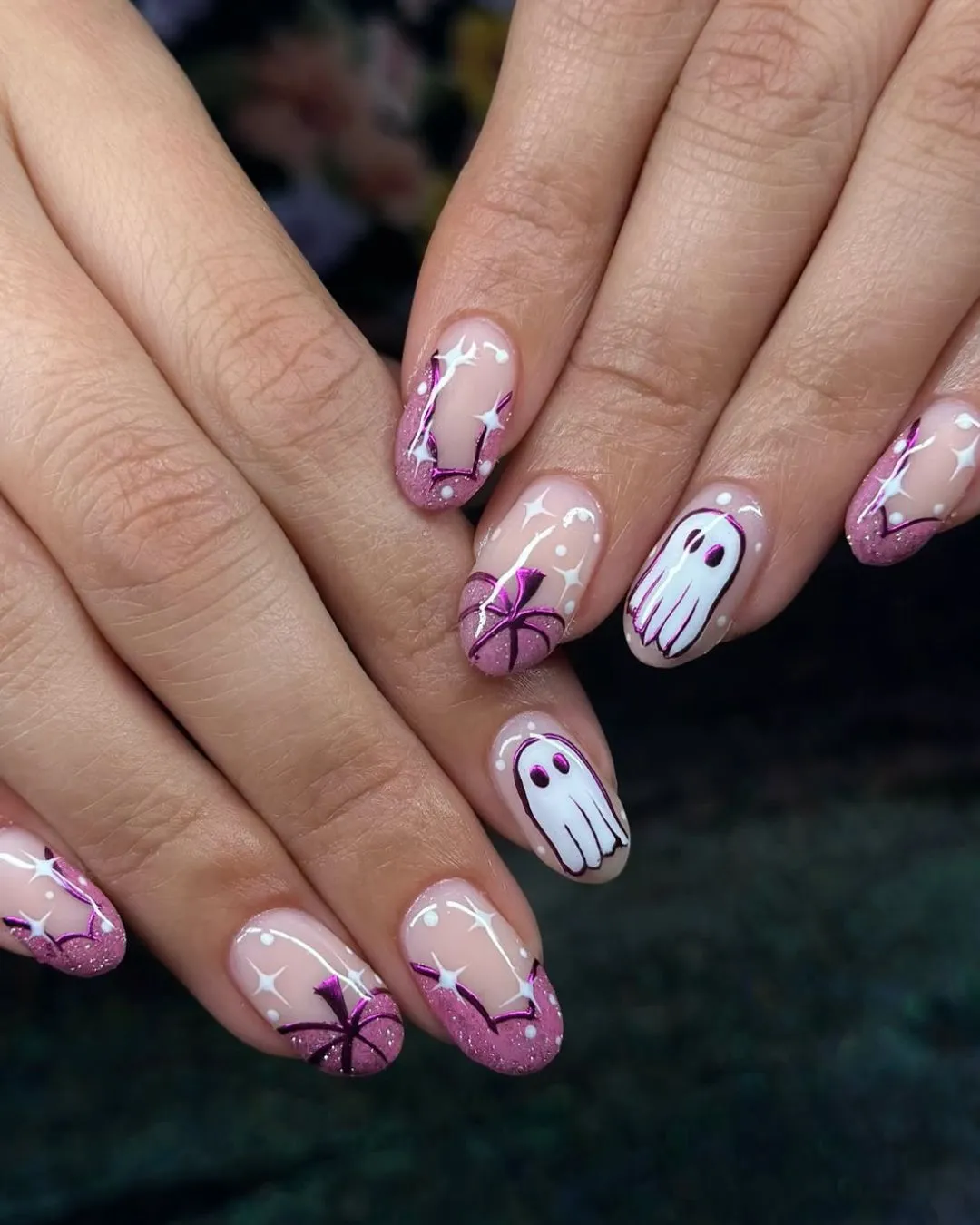 Nude-and-pink glitter tips with ghosts and webs