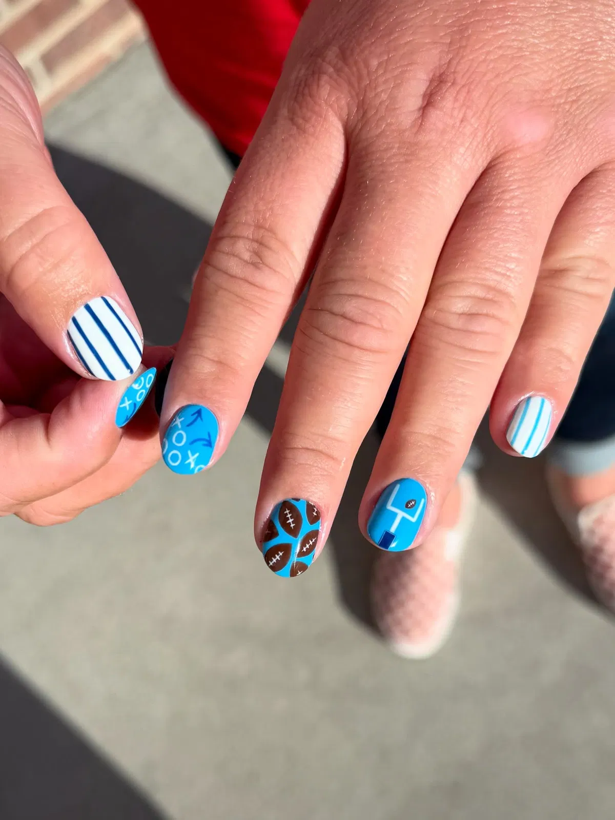 Blue play-diagram nails with striped and football-pattern accents