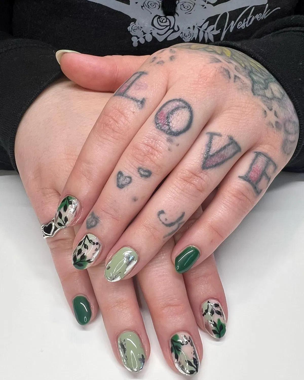Glossy greens with botanical accents and silver foil-style detail