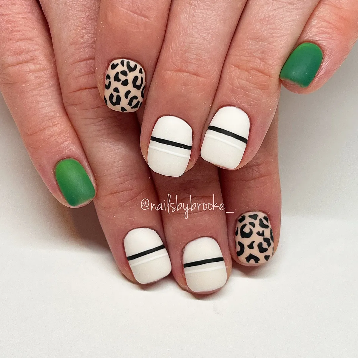 Matte green with leopard accents and striped white nails