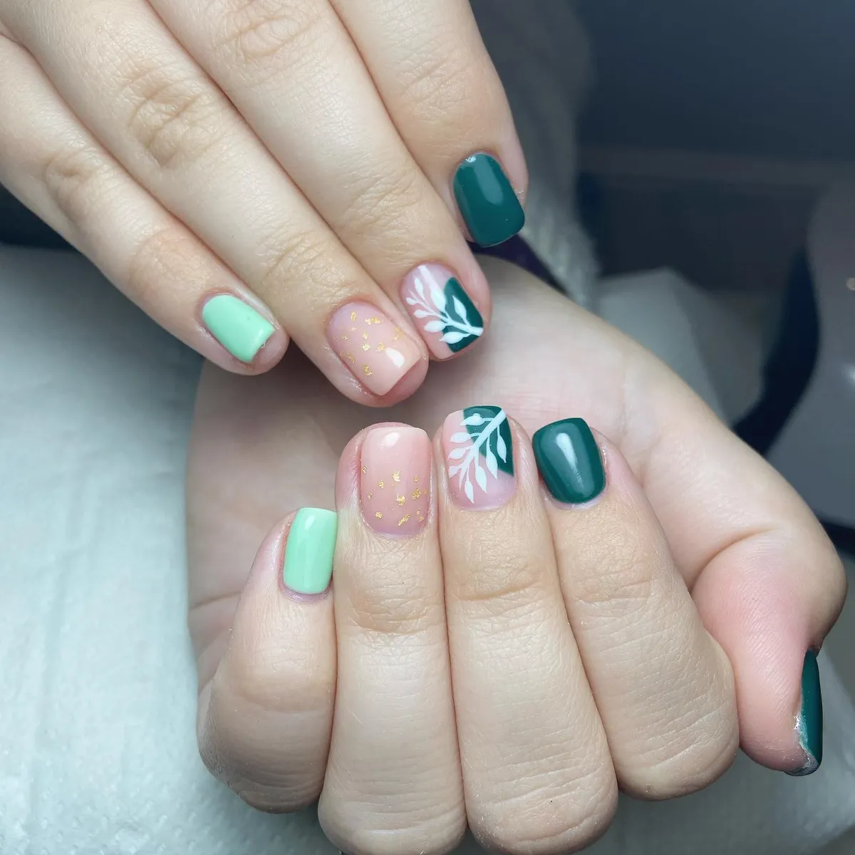 Teal and mint mix with pink-gold flecks and white leaf accents