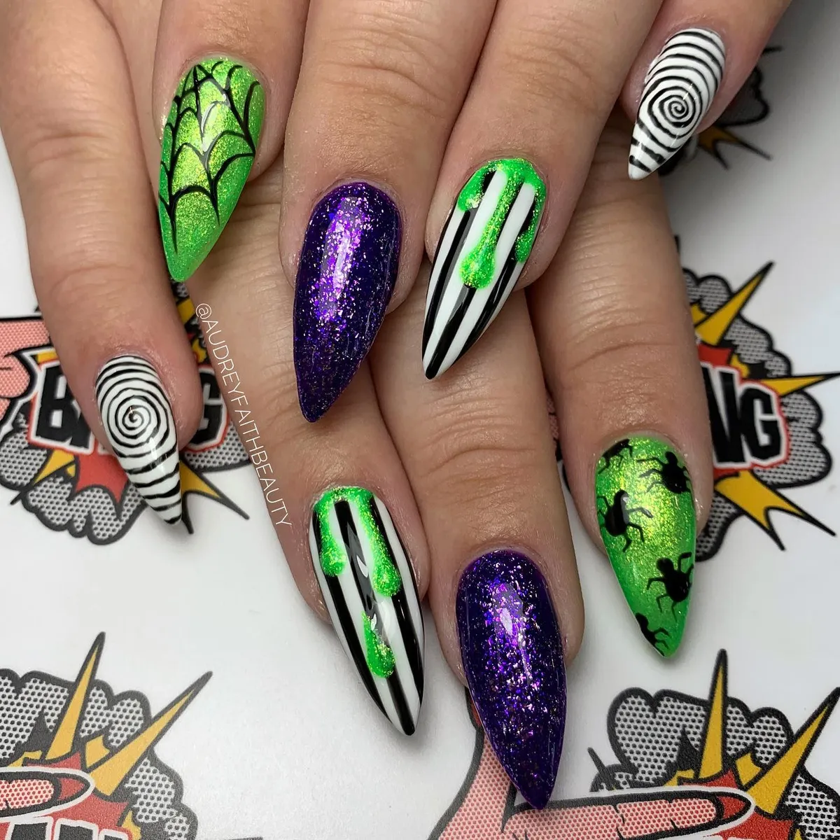 Green, black, and purple glitter mix with stripes, drips, spirals, and spiders