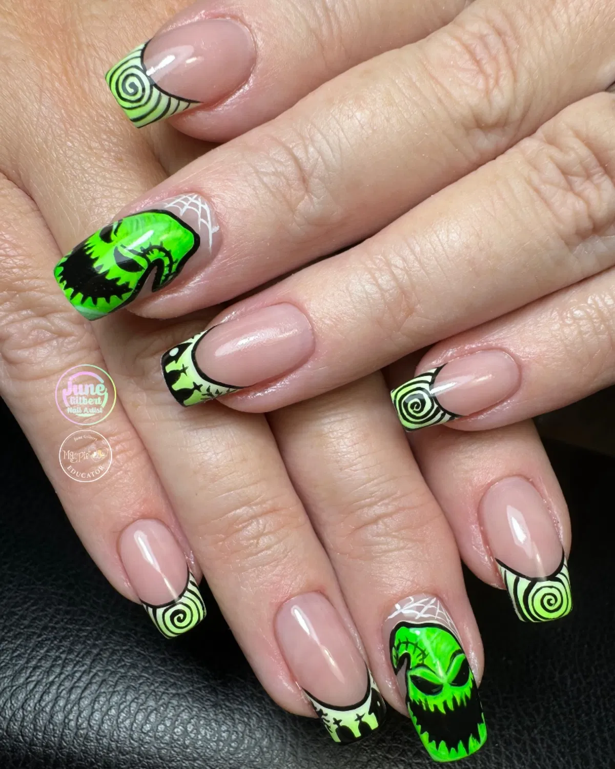 Nude base with green spiral French tips and face accent nails