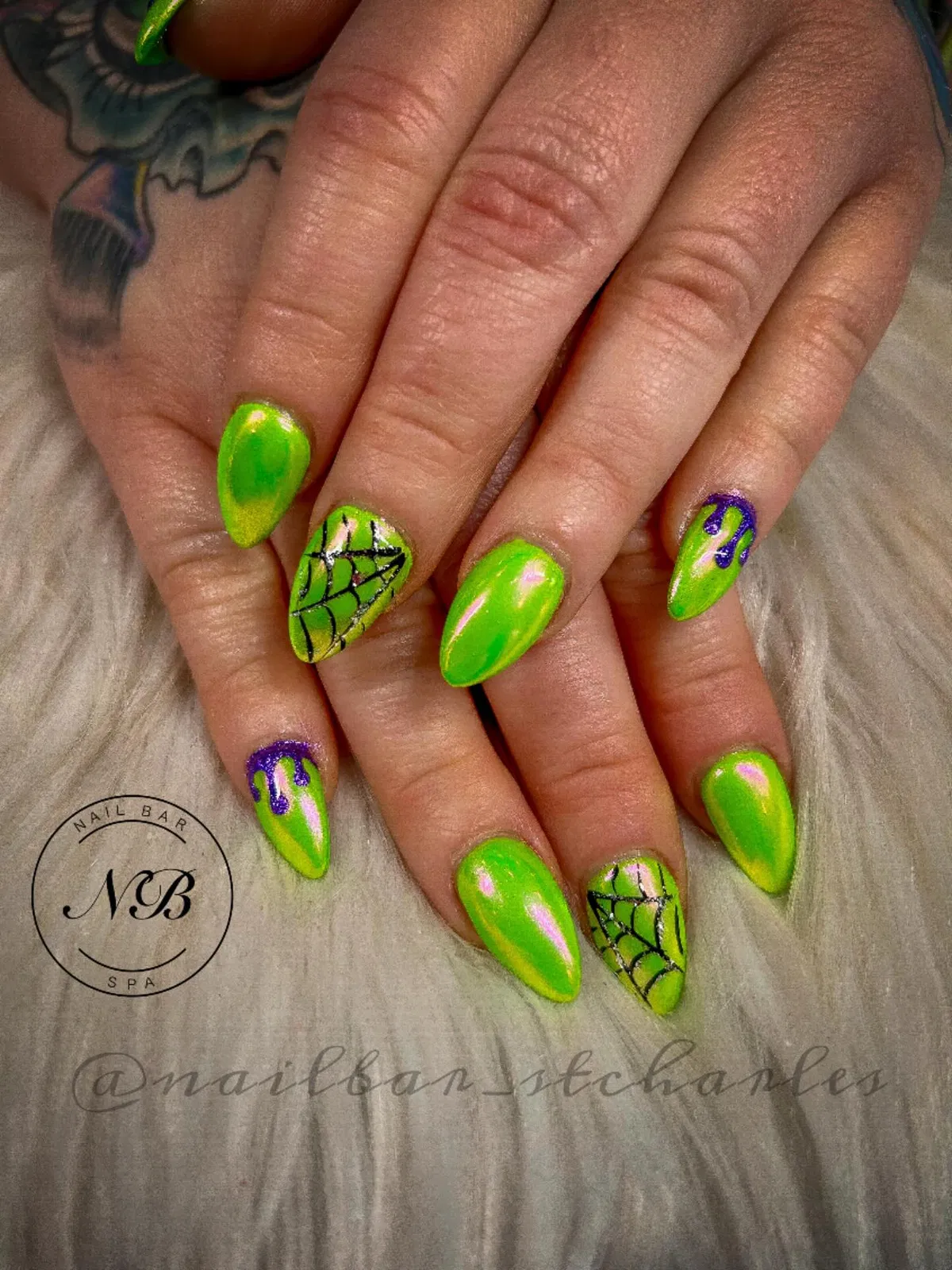 Iridescent yellow-green nails with webs and purple drips
