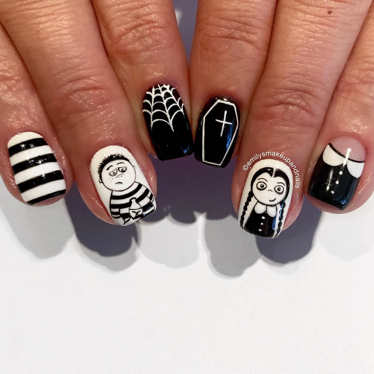 Graphic black-and-white characters with web and coffin details
