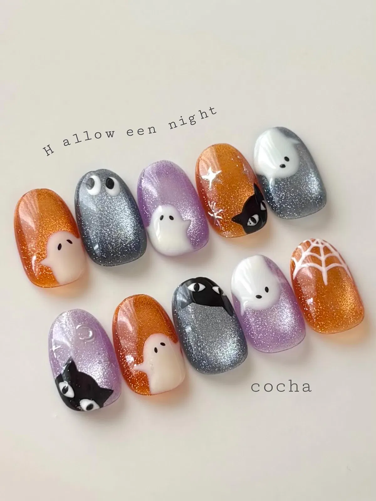 Glitter orange, silver, and lavender set with ghosts, cats, and a web