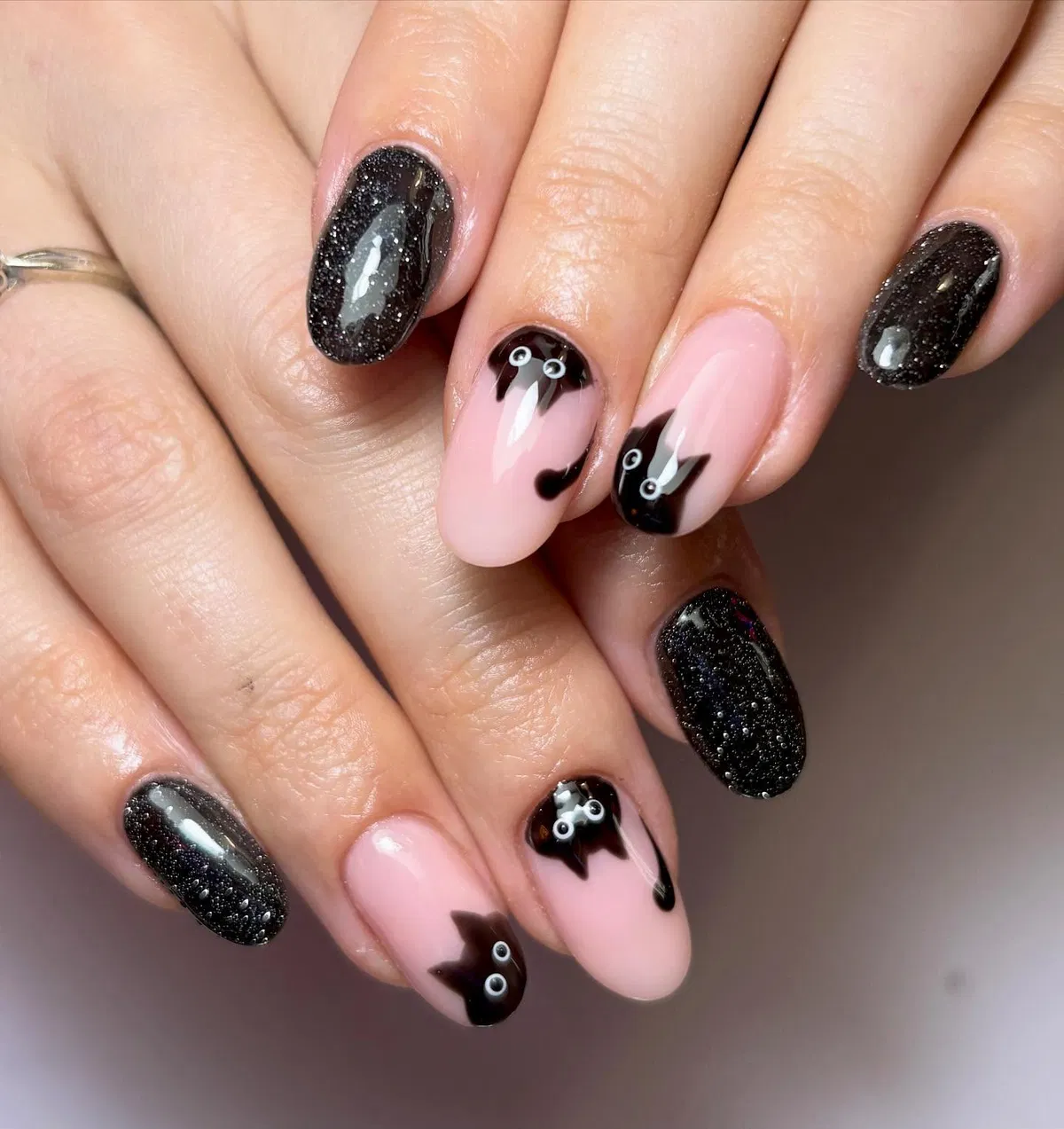 Black glitter and peekaboo cat silhouettes on nude base