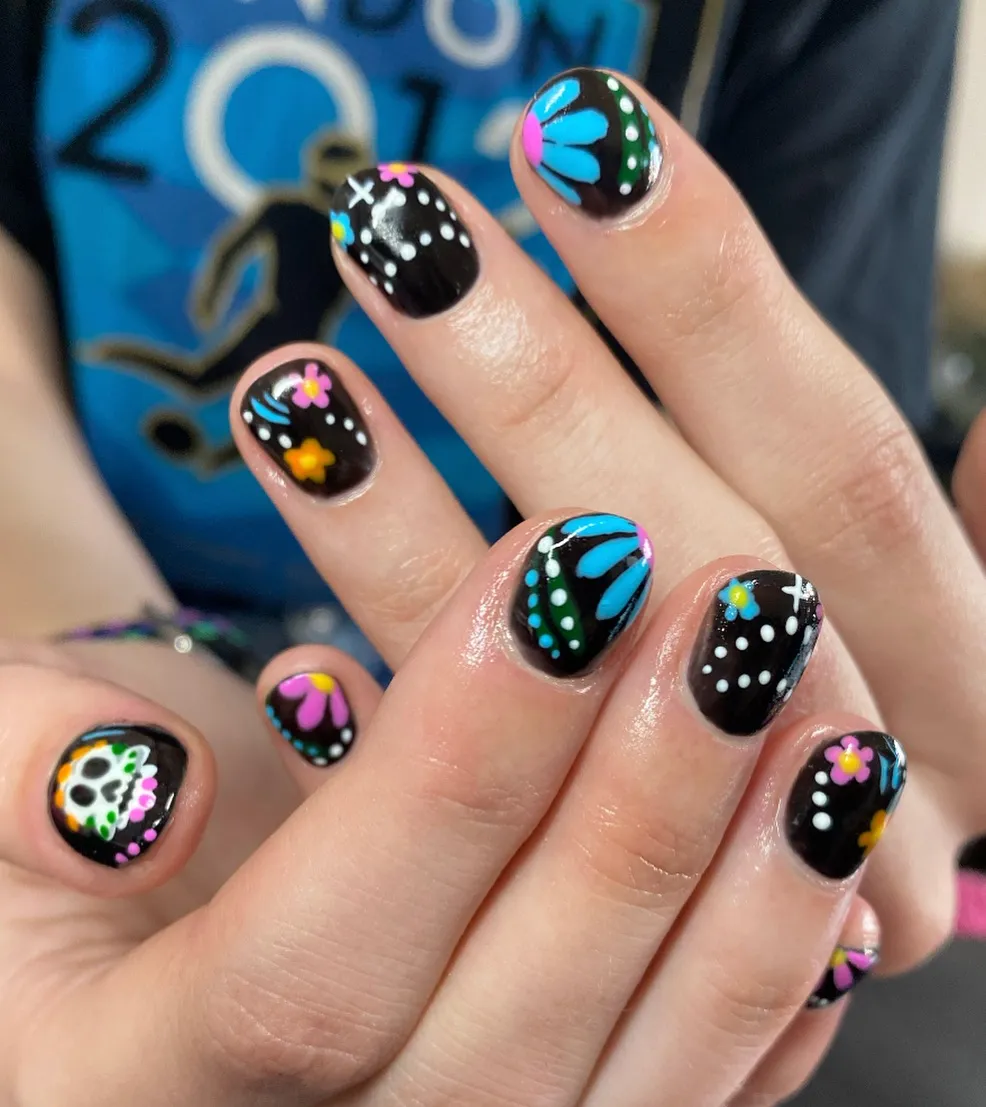 Black base with colorful dots, flowers, and a skull motif