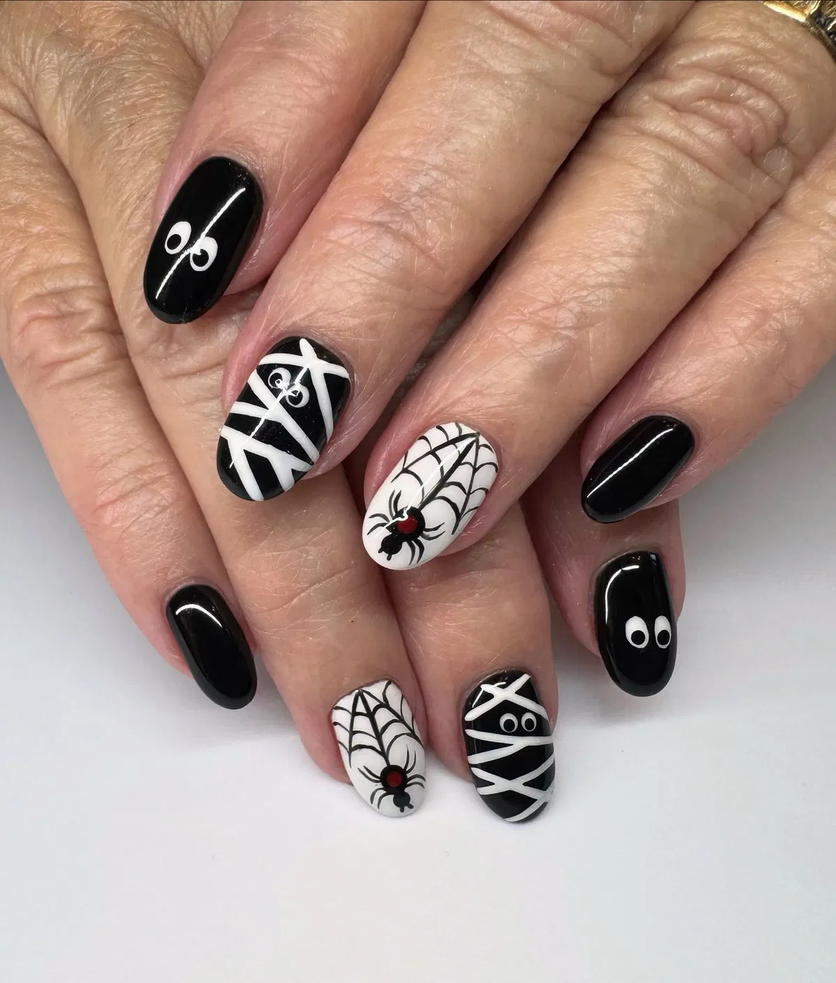 Black-and-white webs, spiders, and crisscross wraps with eyes