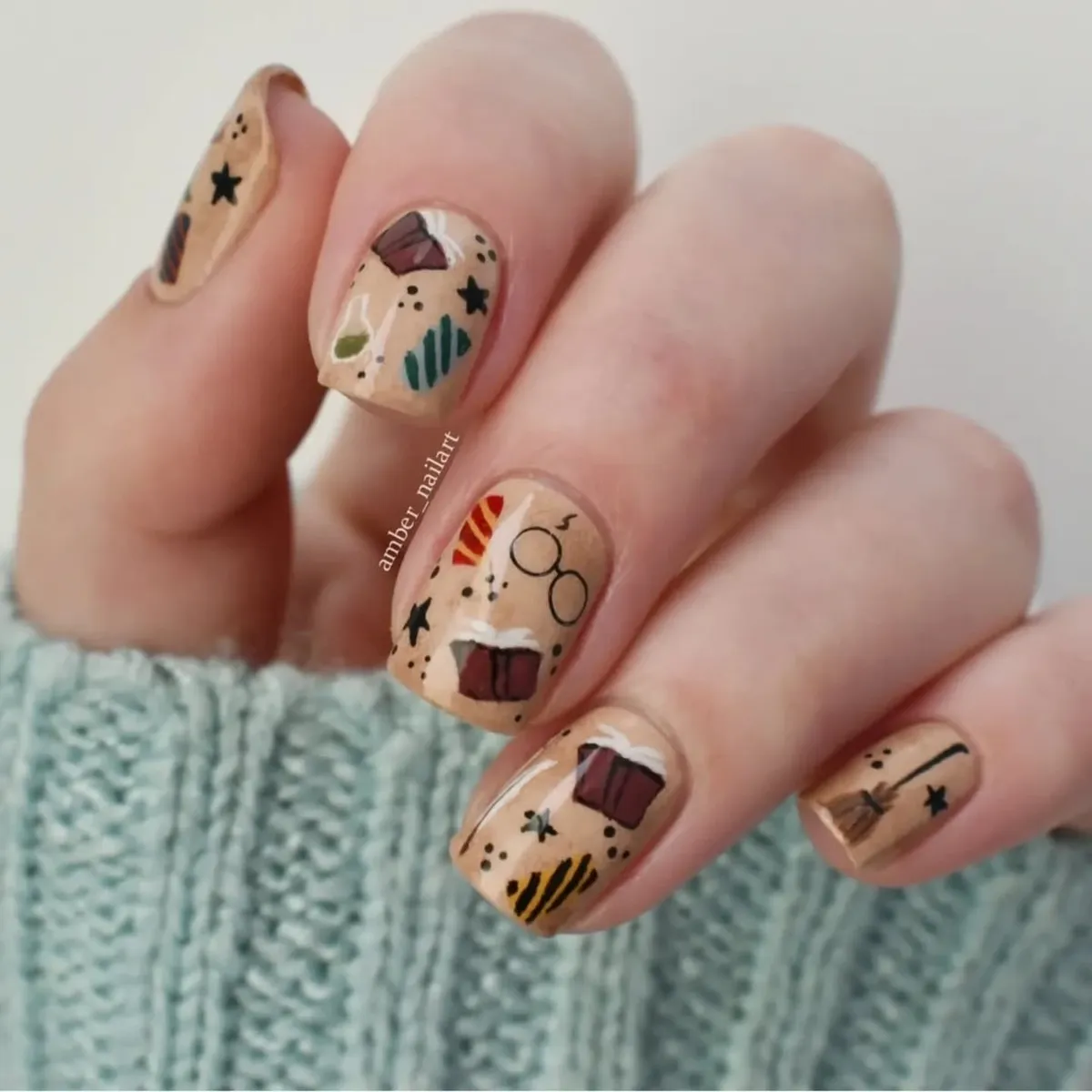 Tan nails with tiny illustrated objects, stars, and dots