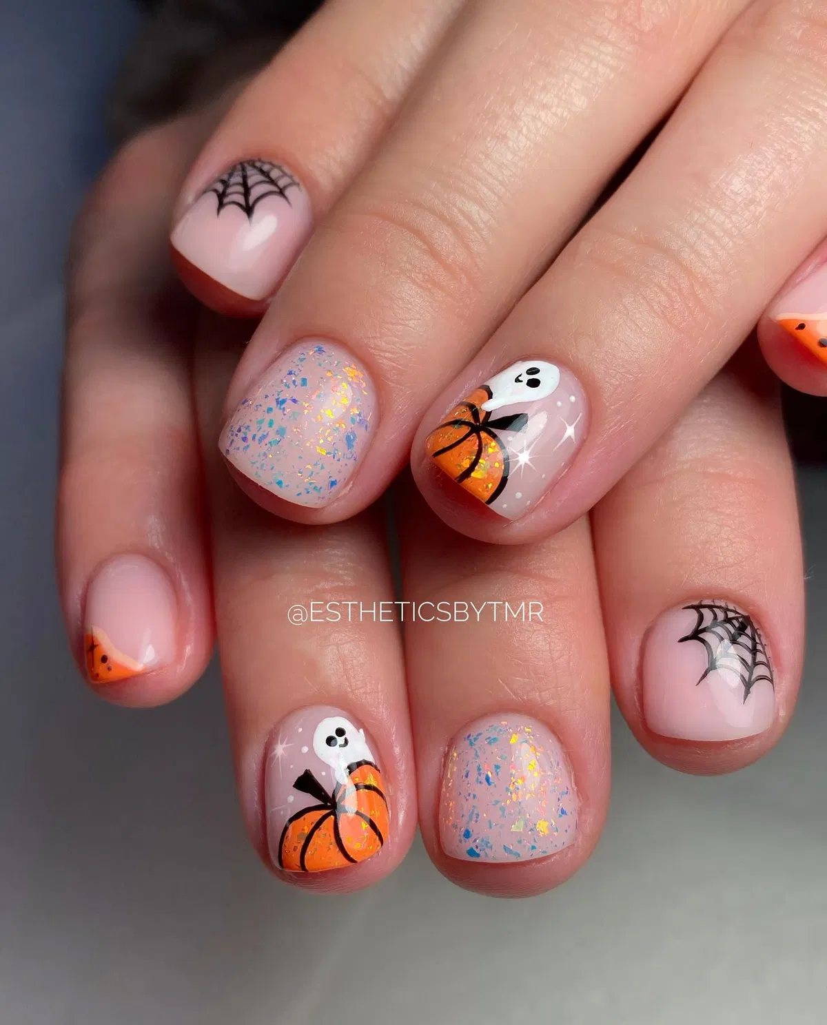 Spiderwebs, candy-corn tips, and pumpkin-with-ghost accents