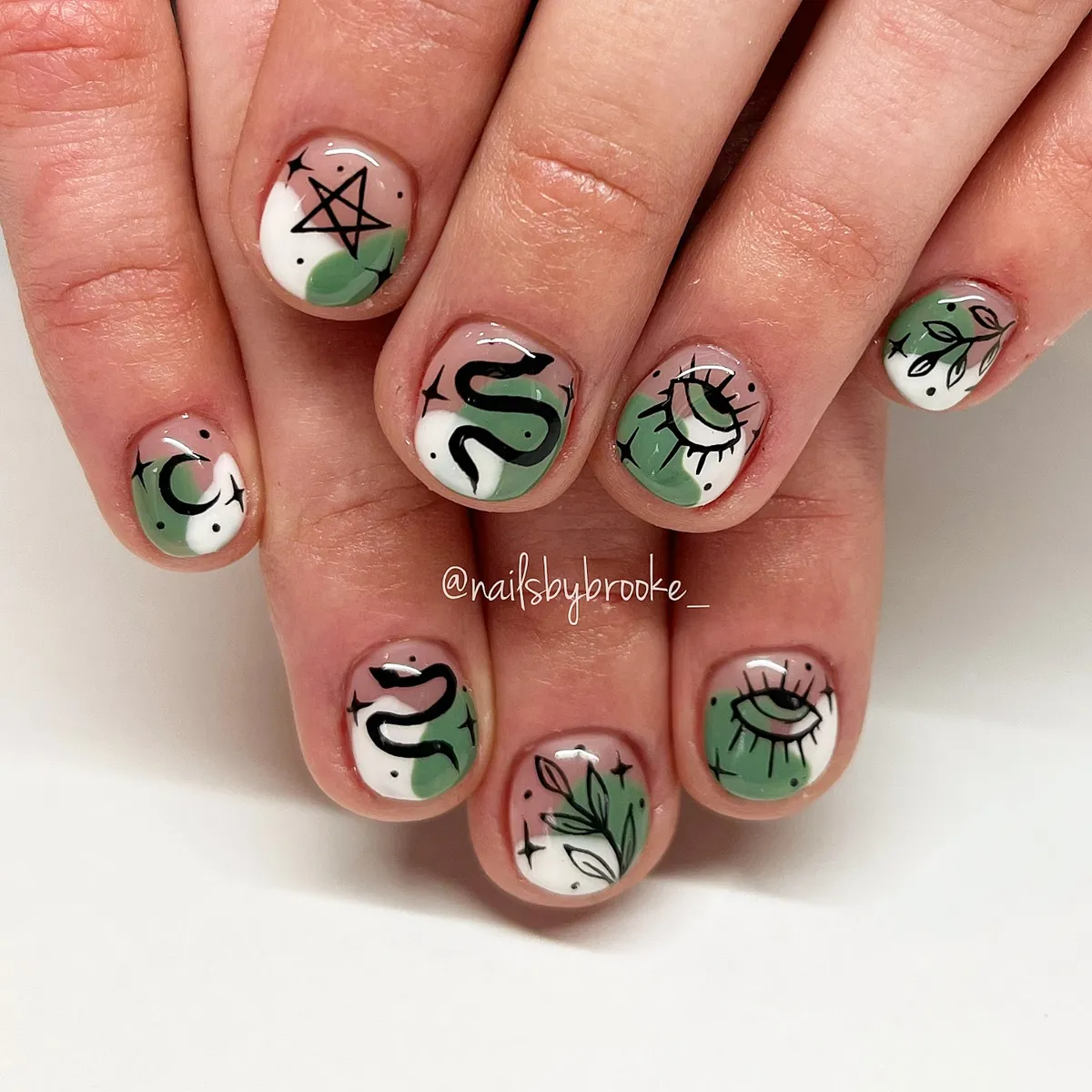 Green-and-white color block with snake, eyes, moon, and leaves